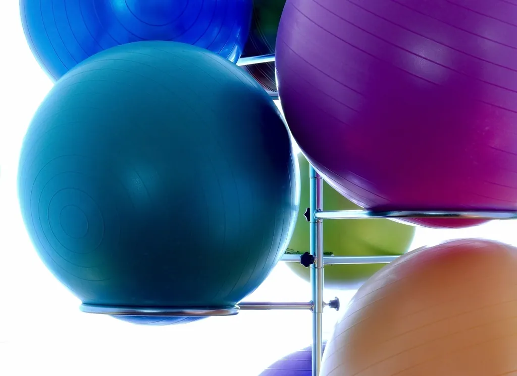 Colourful exercise balls stacked on a rack
